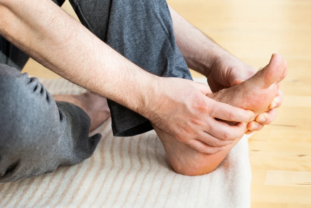 adult massaging foot