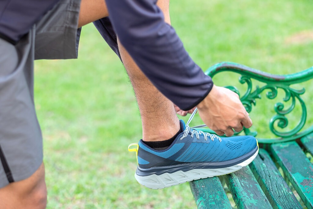 athlete man tying running shoes