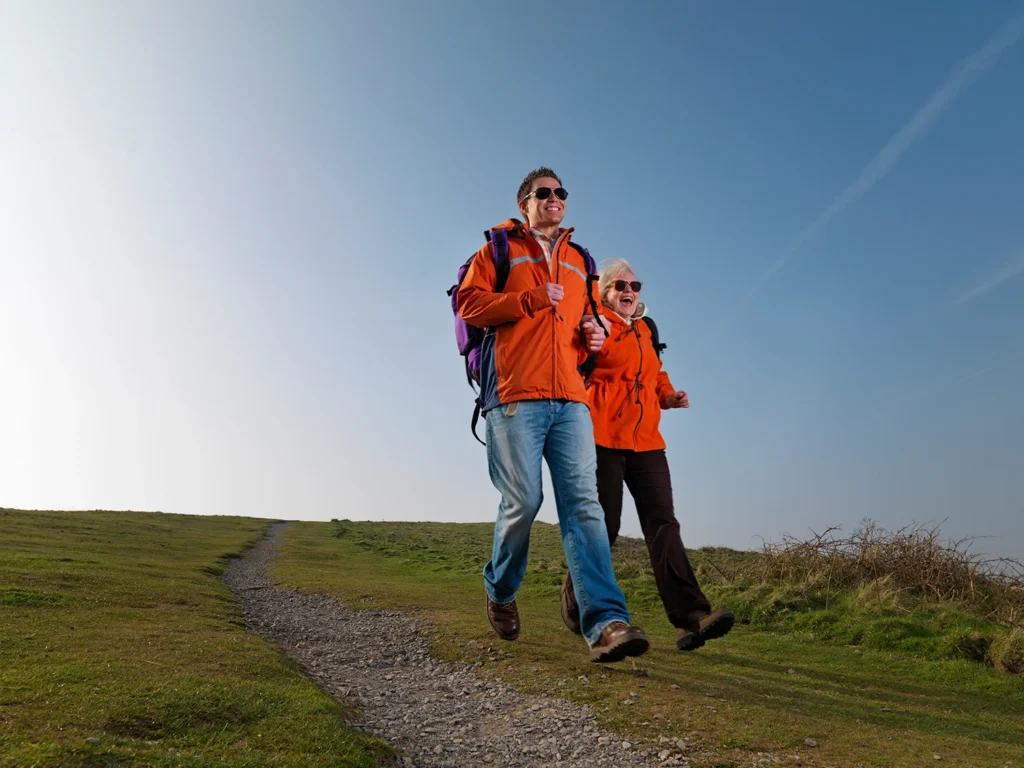 man and woman happily hiking