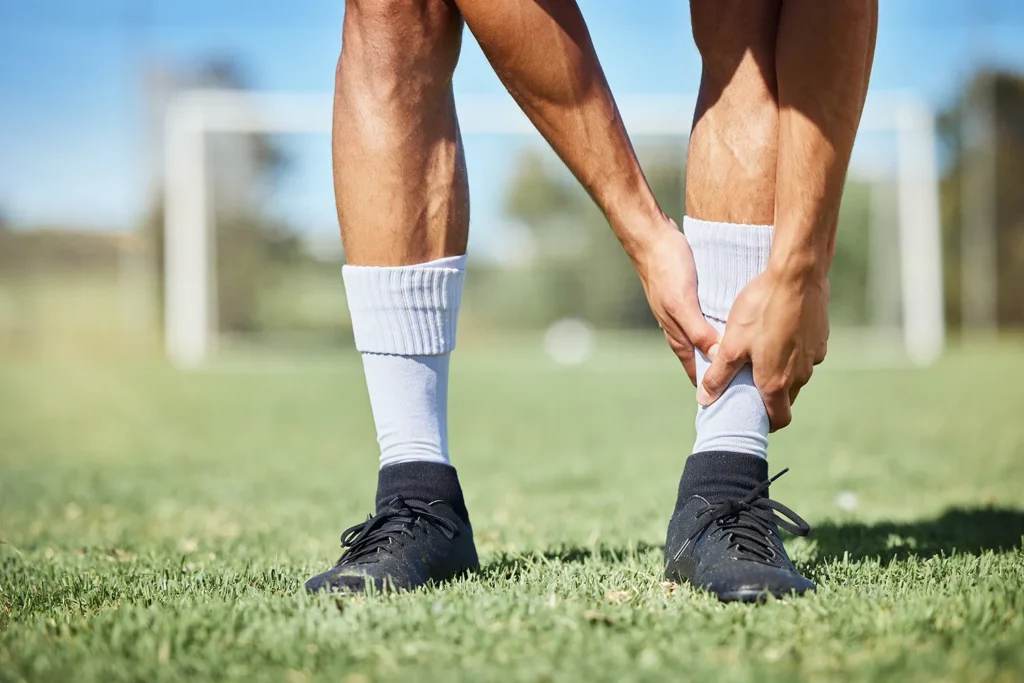 man holding ankle on soccer