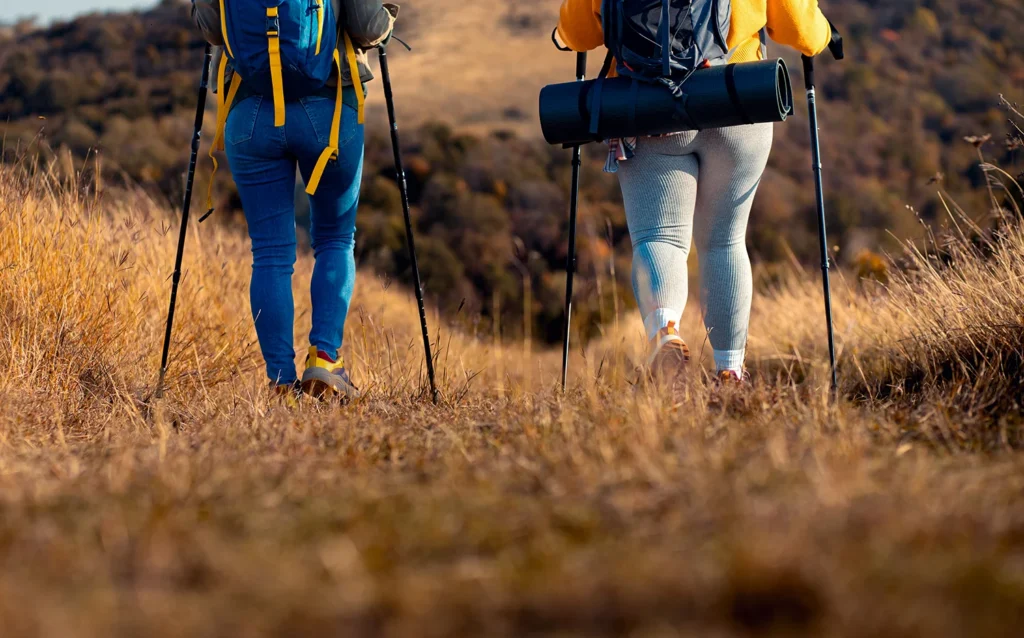 rear view of two woman hiking at top of the hill