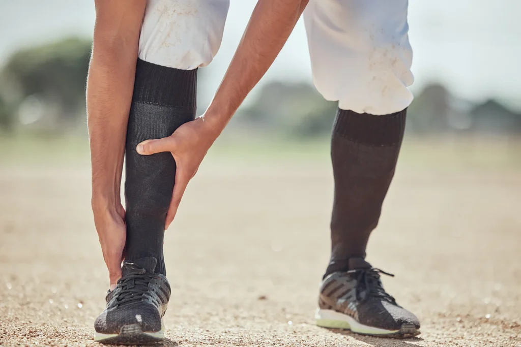 sports field and man with ankle injury